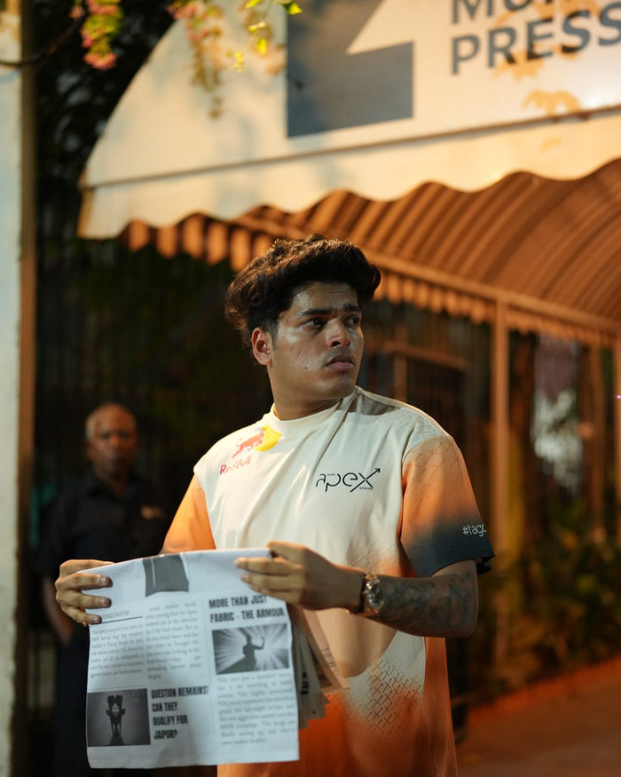 Jonathan holding a newspaper, wearing the jersey